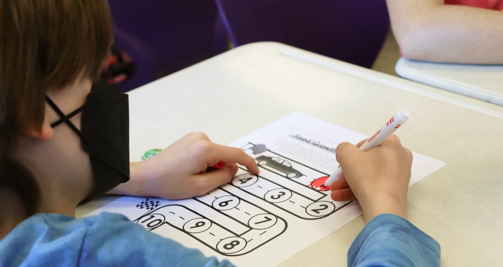 A student working on a classroom activity sheet